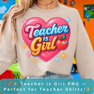 May include: A beige sweatshirt featuring a pink heart with the words "Teacher is Girl" in blue and gold. An apple with an A+ grade is on the right side of the heart. The design is surrounded by stars.