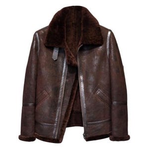 May include: A brown leather jacket with a shearling collar and lining. The jacket has a zip fastening and two pockets.