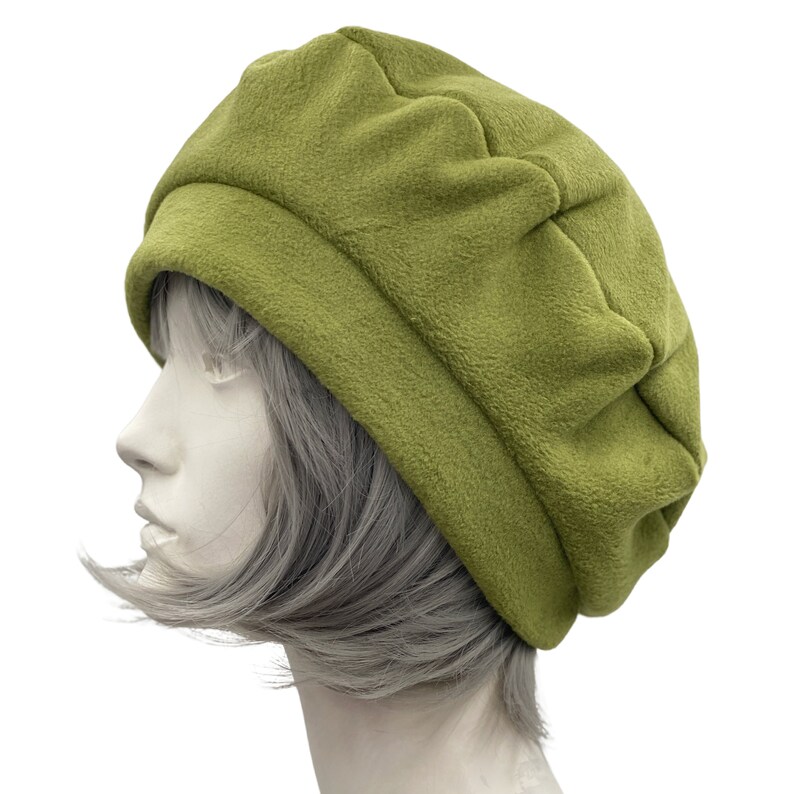 Olive green fleece beret satin lined winter hat modeled on a hat mannequin. Handmade by Boston Millinery side view