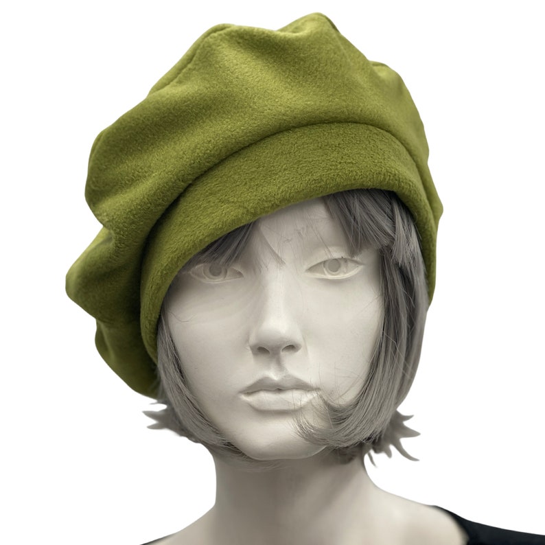 Olive green fleece beret satin lined winter hat modeled on a hat mannequin. Handmade by Boston Millinery front view