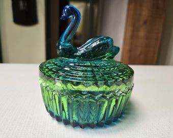 This is a vintage Jeanette swan glass blue and green trinket dish with lid made in 1950s.