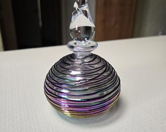 This is a vintage  gorgeous multicolor irridescent and clear art glass hand blown perfume bottle with stopper.