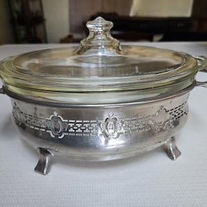 Antique glass pyrex casserole dish 10&quot; x 6.5 &quot; with silverplated footed cradle from the 1920s. Does have origional manufacturing numbers