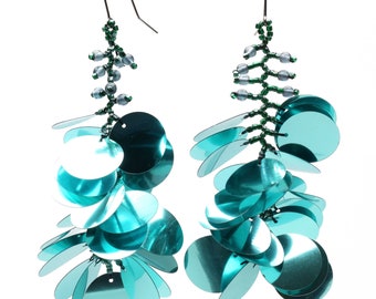 Long dangling earrings made with large colorful light teal colored sequin paillettes on nickel free silver French ear wire