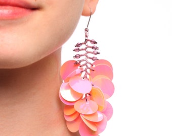 Long dangling statement earrings made with large pink iridescent sequin paillettes and glass seed beads