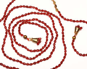 Long red crystal lariat with weighted brass bead endings and mini tassel