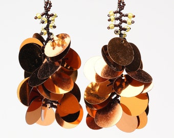 Long dangling statement earrings made with large copper colored sequin paillettes