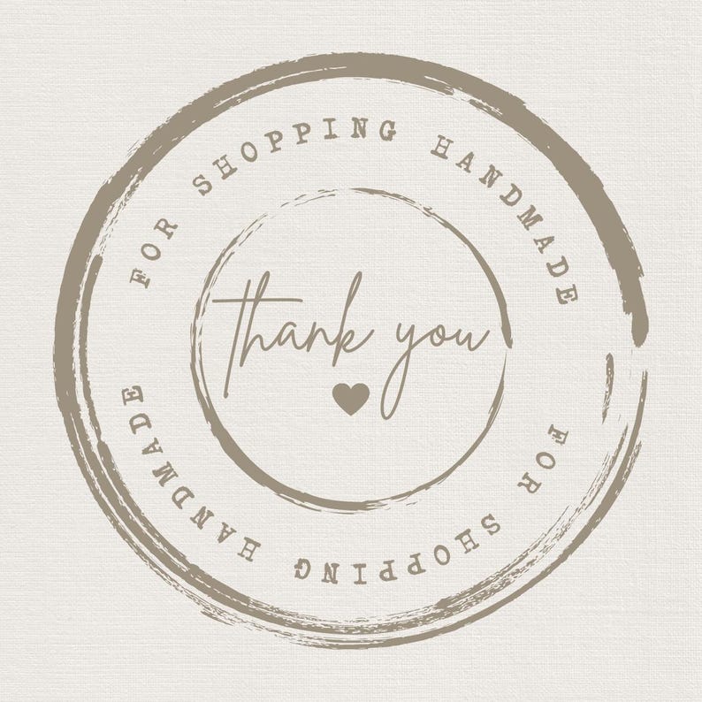 May include: A brown circle with a white background and the text "For Shopping Handmade" and "Thank you" with a small heart in the center. The text is repeated in reverse on the outer circle.