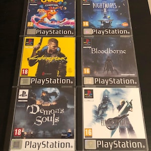 May include: Six PlayStation video game cases arranged in two columns. Titles include Crash Bandicoot 4, Little Nightmares II, Cyberpunk 2077, Bloodborne, Demon's Souls, and Final Fantasy VII. Each case features distinct cover art and age ratings.