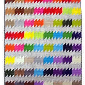 May include: A colorful quilt with a geometric pattern of zigzags in various shades of red, orange, yellow, green, blue, purple, and brown. The quilt is made of fabric squares sewn together to create a repeating pattern.