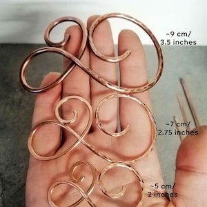 May include: Three copper wire hair clips in different sizes. The largest clip is approximately 3.5 inches long, the middle clip is approximately 2.75 inches long, and the smallest clip is approximately 2 inches long.