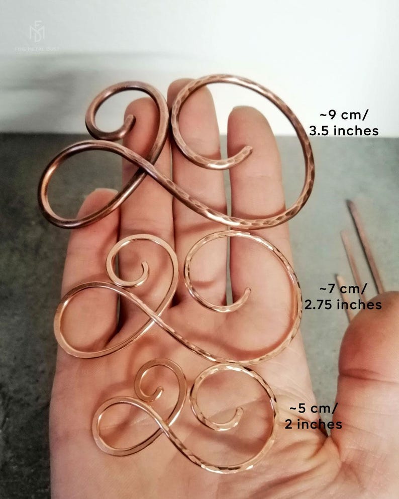 May include: Three copper wire hair clips in different sizes. The largest clip is approximately 3.5 inches long, the middle clip is approximately 2.75 inches long, and the smallest clip is approximately 2 inches long.