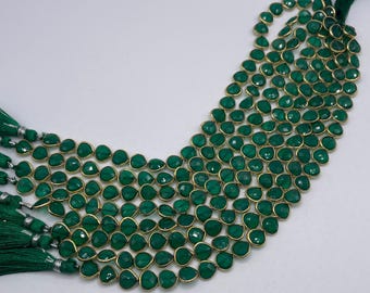 Bezel. Green onyx facetted heart shape bezel with 14k gold plated 5mm. sell by strand. Approximately 24-25 beaded a strand.