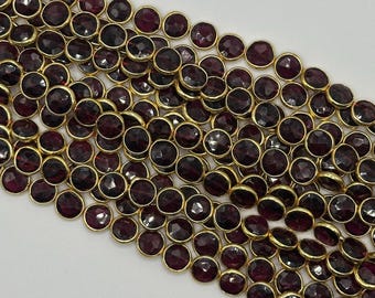 Bezel. Garnet facetted coin shape bezel with 14k gold plated 7mm sell by strand. Approximately 24-25 beaded a strand.