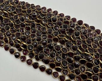 Bezel. Garnet facetted heart shape bezel with 14k gold plated 7mm sell by strand. Approximately 24-25 beaded a strand.