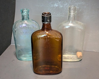 Antique Glass Flask Lot of 3 Aqua Warranted Flask Amber Full Pint Clear
