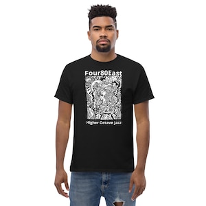 May include: Black t-shirt with white text that reads "Four80East" and "Higher Octave Jazz". The shirt features a white graphic design of a person playing a musical instrument.