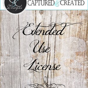 May include: A rustic wooden sign with the text "Captured & Created Designs" and "Extended Use License" in black cursive font. The sign has a distressed white paint finish and a decorative flourish at the bottom.
