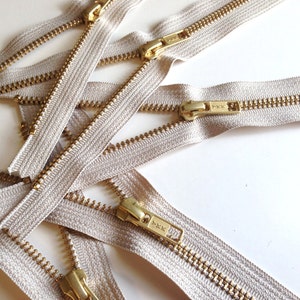 24 inch metal zippers, FIVE brass zippers, natural beige tape, YKK color 572, gold teeth YKK zippers image 1