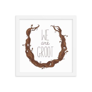 May include: A white framed print with a brown illustration of a tree root in the shape of a circle. The text "WE are GROOT" is written in black inside the circle.
