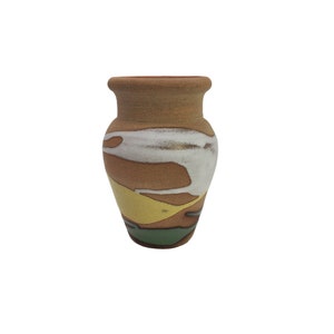 May include: A small, brown ceramic vase with a white, yellow, and green abstract design.