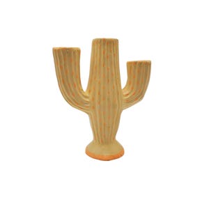 May include: A ceramic cactus-shaped vase with three arms, painted in a light yellow color with orange dots.