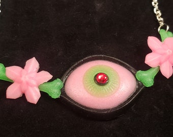 Creepy Crawlers Necklace Glow in Dark Eye with Bones with Red Sparkle center and flowers