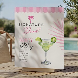 May include: A rectangular white sign featuring a pink palm tree icon, a pink scalloped top border, and the text Signature Drink Spicy Marg. The sign displays a list of ingredients and an illustration of a margarita glass with lime and jalapeño.