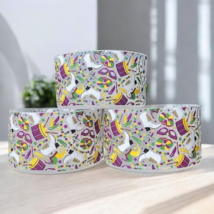 May include: Three clear glass bowls with a Mardi Gras themed design. The bowls feature a white background with purple, green, and gold Mardi Gras themed illustrations.