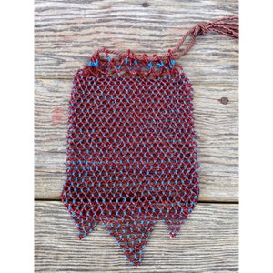 May include: A red and blue beaded bag with a drawstring closure and a tassel. The bag is made of small, round beads that are woven together in a pattern.