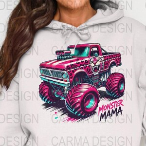 Puede incluir: Un cami&oacute;n monstruo rosa con un dise&ntilde;o de estampado de leopardo y una cabeza de tigre rugiente en el cap&oacute;. El cami&oacute;n tiene neum&aacute;ticos grandes y est&aacute; conduciendo sobre un fondo blanco. El texto "Monster Mama" est&aacute; impreso debajo del cami&oacute;n.