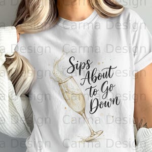 Könnte beinhalten: Weißes T-Shirt mit dem Text "Sips About to Go Down" in schwarzer Schrift, begleitet von einer Champagnerglas-Illustration. Das Glas ist mit sprudelnder Flüssigkeit gefüllt, mit Spritzern und goldenen Akzenten.