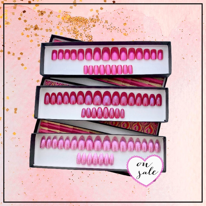 Three rectangular boxes contain sets of pink press on nails in square, oval and stiletto shapes on a pink background with gold splash detail. white heart graphic on lower left reads on sale in black text.