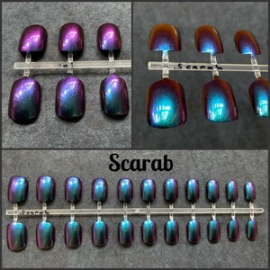 Short purple to green false nails shown on a black background. Top two photos show close up view. Text reads scarab. bottom picture shows full set of 24 press on nails.