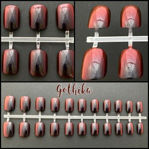 Short red to black duochrome false nails shown on a white background. Top two photos show close up view. Cursive ext reads Gothika. bottom picture shows full set of 24 press on nails.