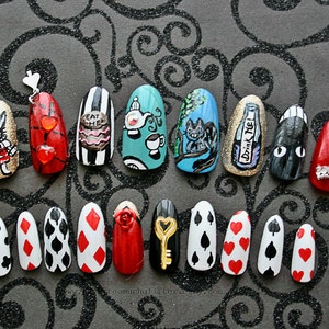 Twenty hand-painted press on nails depicting items from Alice In Wonderland, including Tea, Rabbit, a Top Hat, Cheshire Cat, "Drink Me" bottle, "Eat Me" cake, clock, and playing card designs