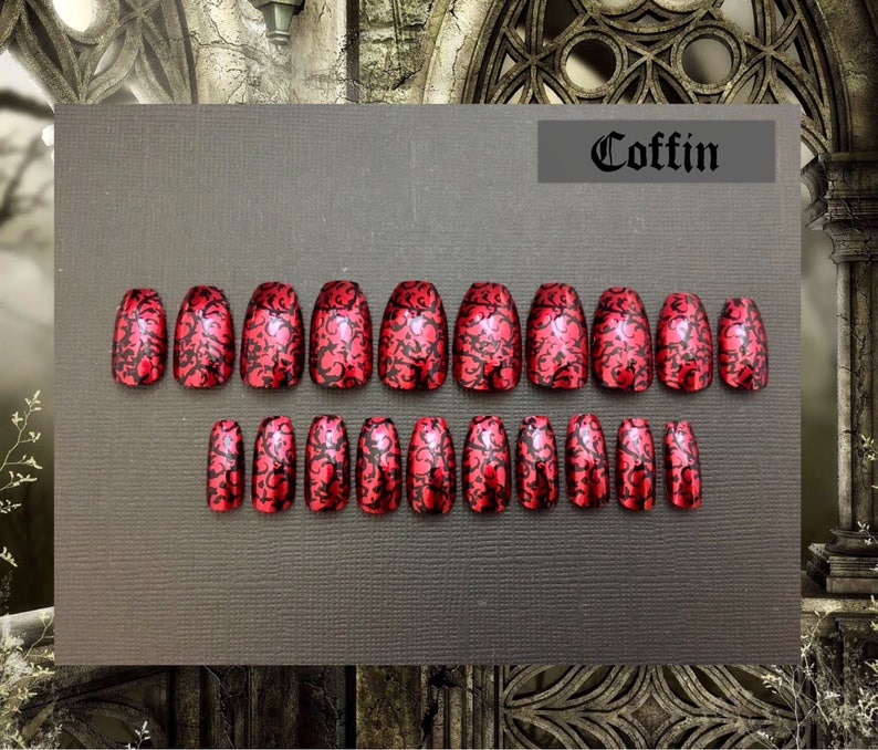 photo shows full set of 20 red coffin shaped nails with black detailing on black background. photo frame is of a gothic church detail. Text on upper right reads coffin.