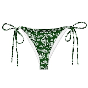 May include: Green paisley print bikini bottoms with white lining and tie closures. The bikini bottoms feature a classic paisley pattern in white on a green background. The ties are green with a white paisley design.