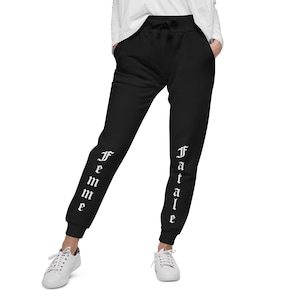 May include: Black sweatpants with the words "Femme Fatale" printed vertically down the legs in white.