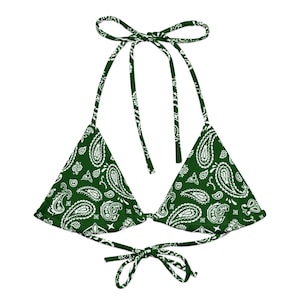 May include: A green and white paisley print bikini top. The triangle-shaped top has adjustable ties at the neck and back. The fabric features a classic bandana pattern in white on a dark green background.