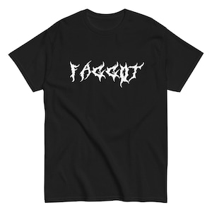 May include: Black t-shirt with the word "FAGGOT" in white, gothic-style lettering across the chest. The shirt is a basic crew neck style, with short sleeves. The fabric appears to be a soft cotton blend.