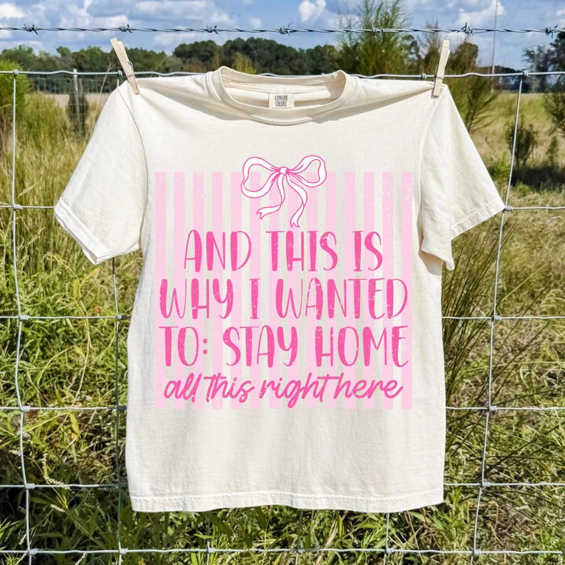 Mockup of a white t-shirt featuring the 'Stay At Home Homebody' sarcastic introvert sublimation design.