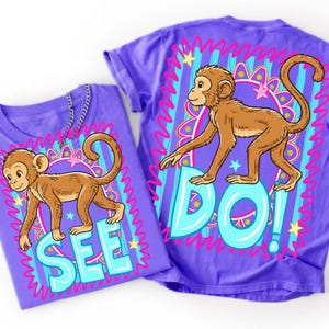 May include: Two purple t-shirts with cartoon monkey graphics. One shirt says "SEE" in turquoise letters, and the other says "DO!" The monkeys are brown with tan fur, set against a colorful, patterned background.