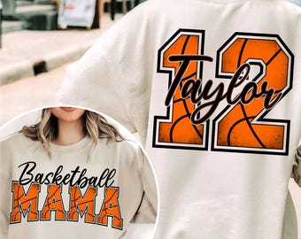 May include: A white sweatshirt with the text "Basketball Mama" printed on the front and the number "12" with the name "Taylor" printed on the back. The number is surrounded by an orange basketball design.