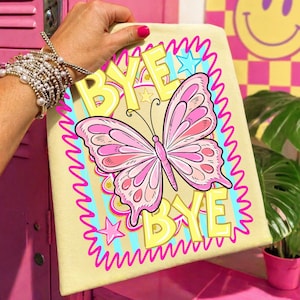 May include: A light yellow canvas featuring a pink butterfly illustration and the words "BYE BYE" in yellow. The butterfly has pink and white details, outlined in black. The text and butterfly are framed by a wavy pink border with blue and yellow accents.