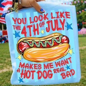 May include: Light blue t-shirt with a hot dog graphic and the text "You look like the 4th of July. Makes me want a hot dog real bad." The design includes red, yellow, and blue colors.