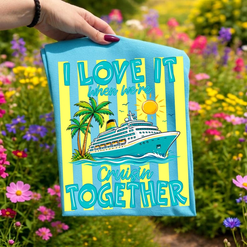 May include: A light blue t-shirt with a cruise ship graphic, palm trees, and the text "I LOVE IT when we're Cruisin TOGETHER". The design features yellow and blue vertical stripes and a sun.