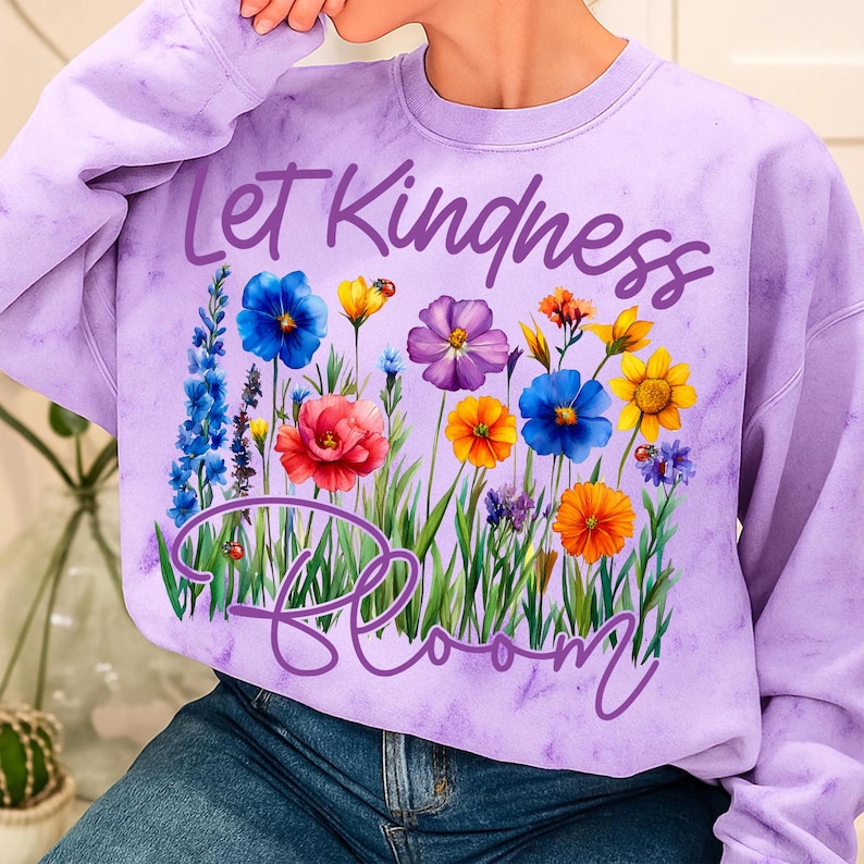 Close-up of the 'Let Kindness Bloom' hand-lettered typography with watercolor wildflowers, ideal for DTF and custom shirt designs.
