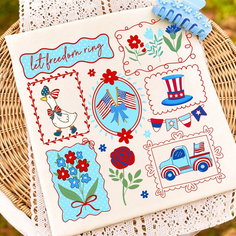 May include: A cream-colored fabric featuring patriotic illustrations in red, white, and blue. Designs include a goose, flags, flowers, a truck, and the text "let freedom ring." A blue hair clip rests on the top right.