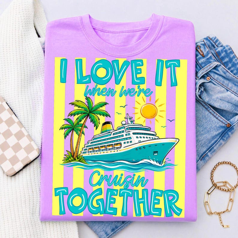 May include: A lilac t-shirt with a colorful graphic design. The design features a cruise ship, palm trees, and a sun, with the text "I LOVE IT when we're Cruisin' TOGETHER" in turquoise and yellow.